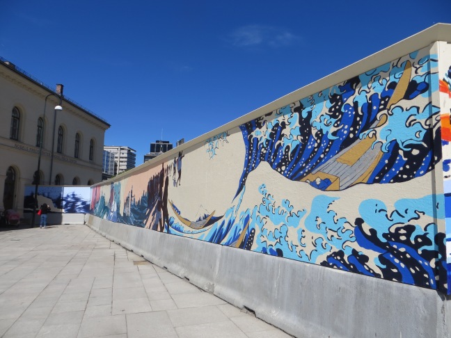 Murals surrounding the Nobel Peace Center, representing different cultures and conflicts.